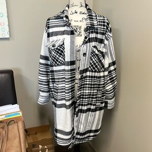 Gentle worn B&W flannel like coat. Falls above the knees in length. Size M